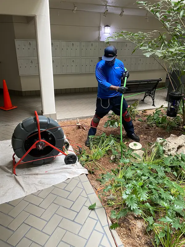carrollwood-village-plumber-hydro-jetting-drain-line-cleaning Carrollwood Village plumber performing hydro jetting with high-pressure hose to clear and clean building drain lines for improved flow and blockage removal