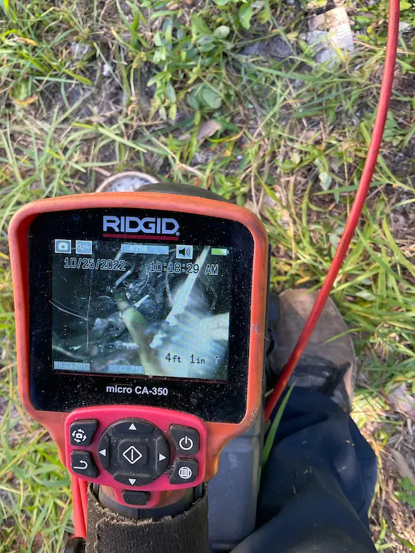 plumber-video-camera-drain-inspection Sewer video camera inspection monitor showing inside of drain line to locate blockages, leaks, or damaged pipes